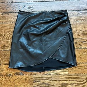 Rewash vegan leather mini skirt with cross front, size small.